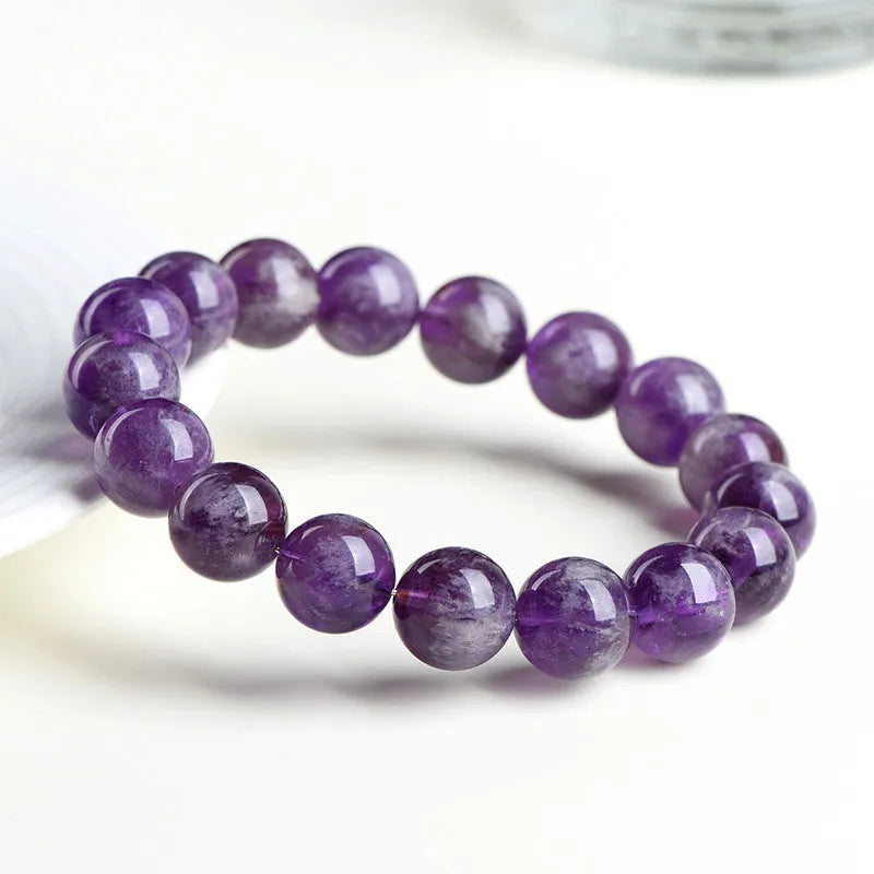 Natural feather amethyst bracelet with scattered purple crystal beads and Ruyi elements on wrist
