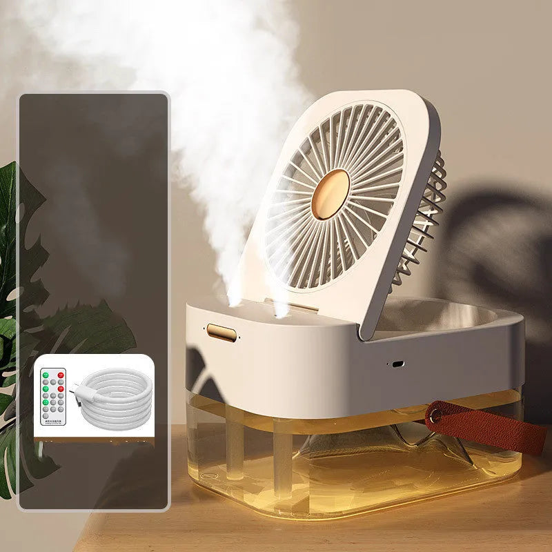 White or green USB desktop mist fan with large water tank, remote control, and dual spray nozzles on a desk.