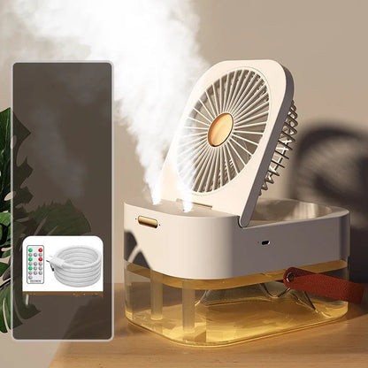 White or green USB desktop mist fan with large water tank, remote control, and dual spray nozzles on a desk.