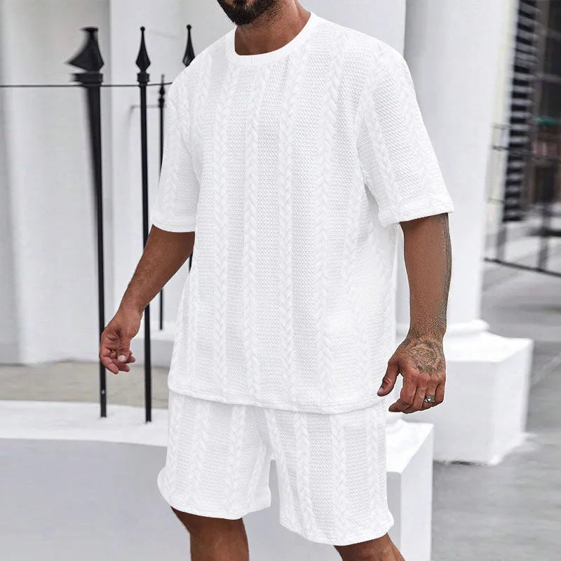 Knitted short-sleeve pullover and matching shorts set in light grey, laid flat.