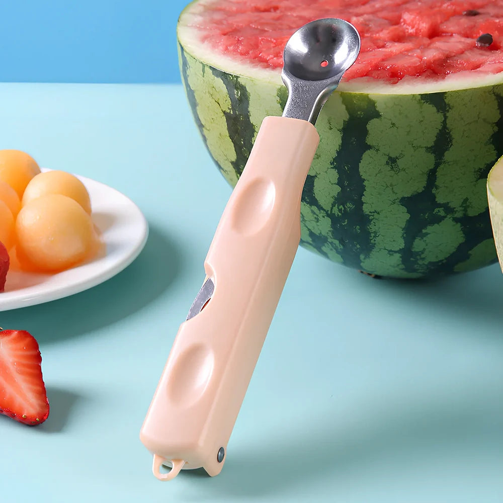 Three-in-one stainless steel watermelon ball digger in grass green, 24cm long with hidden knife and 10cm scoop for fruit slicing