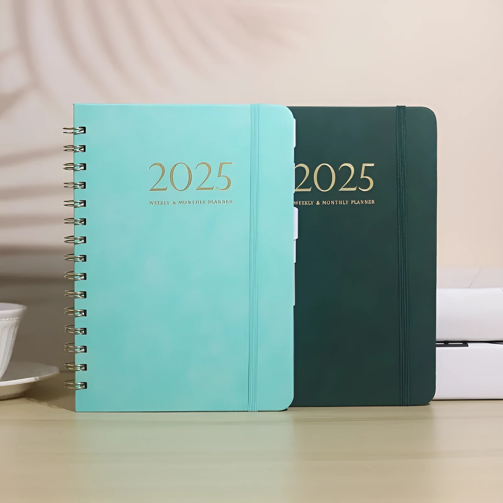 A5 size PU leather notebook with metal coil binding in a choice of colours including black, blue, and brown.