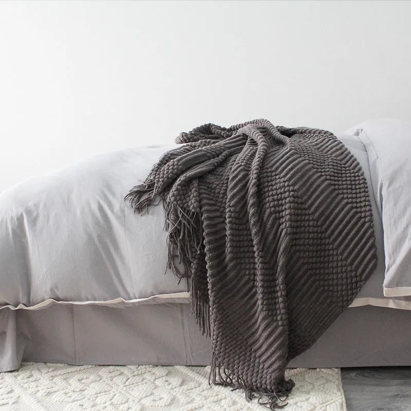 Small grey polyester fibre nap blanket folded, showing dimensions of 127 cm by 170 cm.