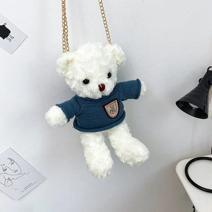 A plush teddy bear crossbody messenger bag with an adjustable shoulder strap and a zippered interior pocket for convenient storage.