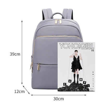 Oxford cloth women's backpack in black or purplish grey showing large capacity and padded straps