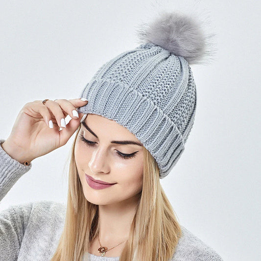 Cozy satin-lined knit beanie with plush faux fur pom-pom in various colors for women