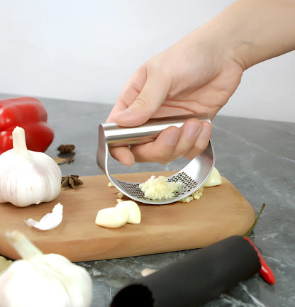 Stainless steel garlic press with uniform mincing holes measuring 10.5cm in length