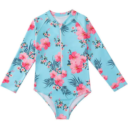 Girl's long-sleeve one-piece swimming suit in a briefs style on a hanger.