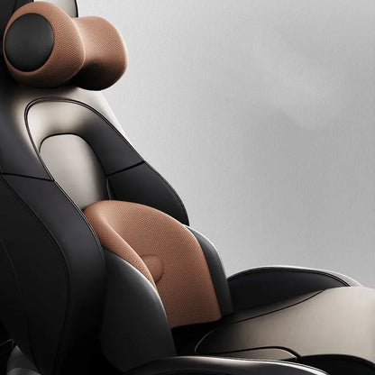 Black car massage cushion with adjustable straps attached to a car seat headrest