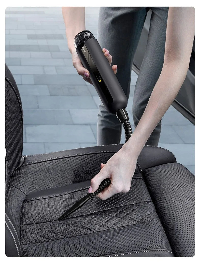BASEUS handheld car vacuum cleaner in black with blowing hose attachment, showing compact size and dust bin