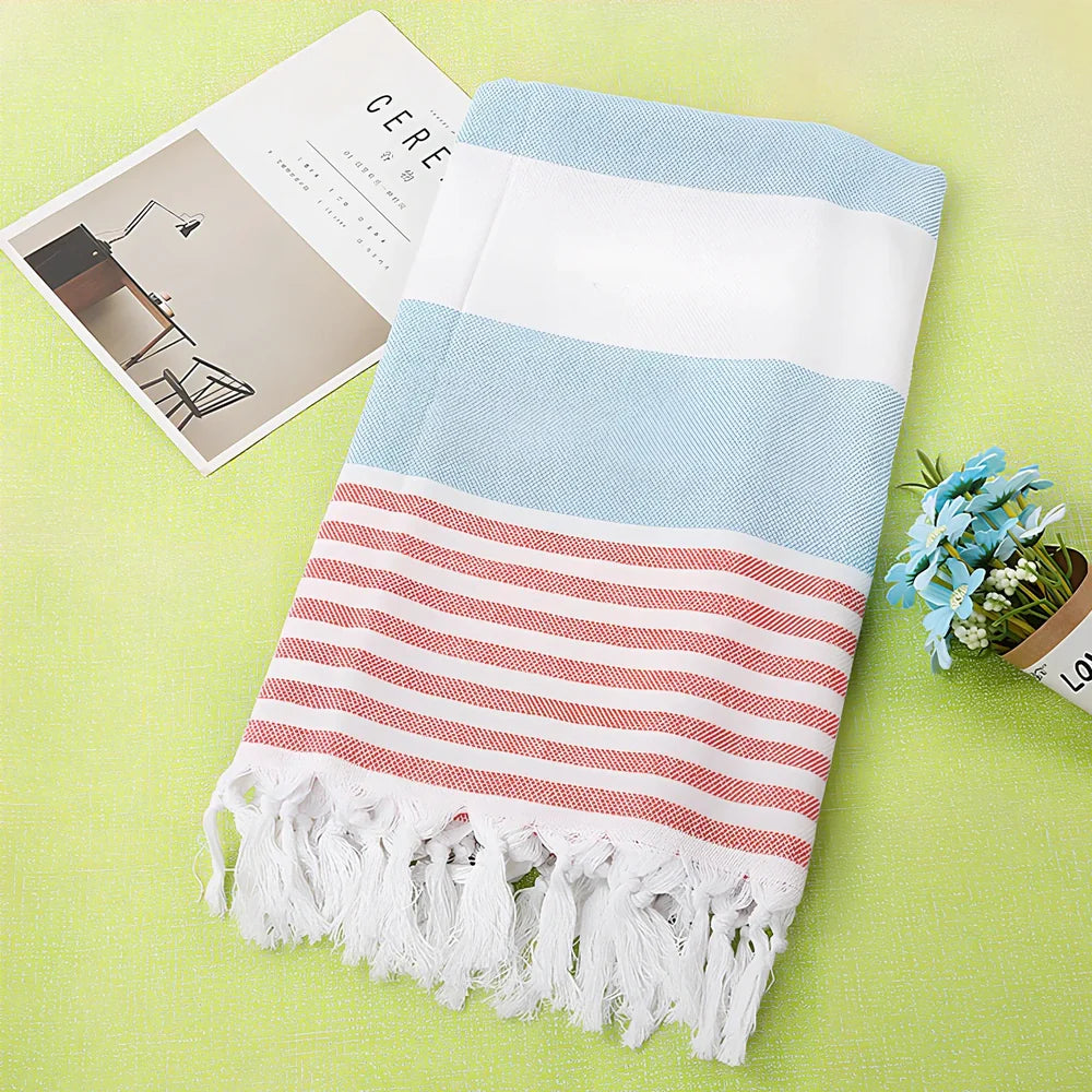 Striped Turkish beach towel showing blue and white pattern, measuring 100cm by 180cm