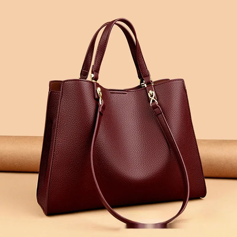 Women's horizontal square messenger tote bag in PU leather with crossbody strap and internal compartments.
