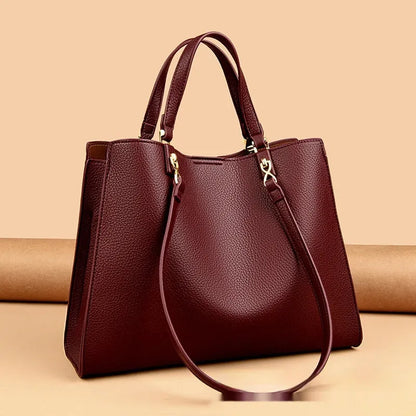 Women's horizontal square messenger tote bag in PU leather with crossbody strap and internal compartments.