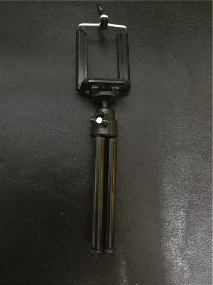 Silver adjustable desktop phone holder with two-section bracket on a wooden desk
