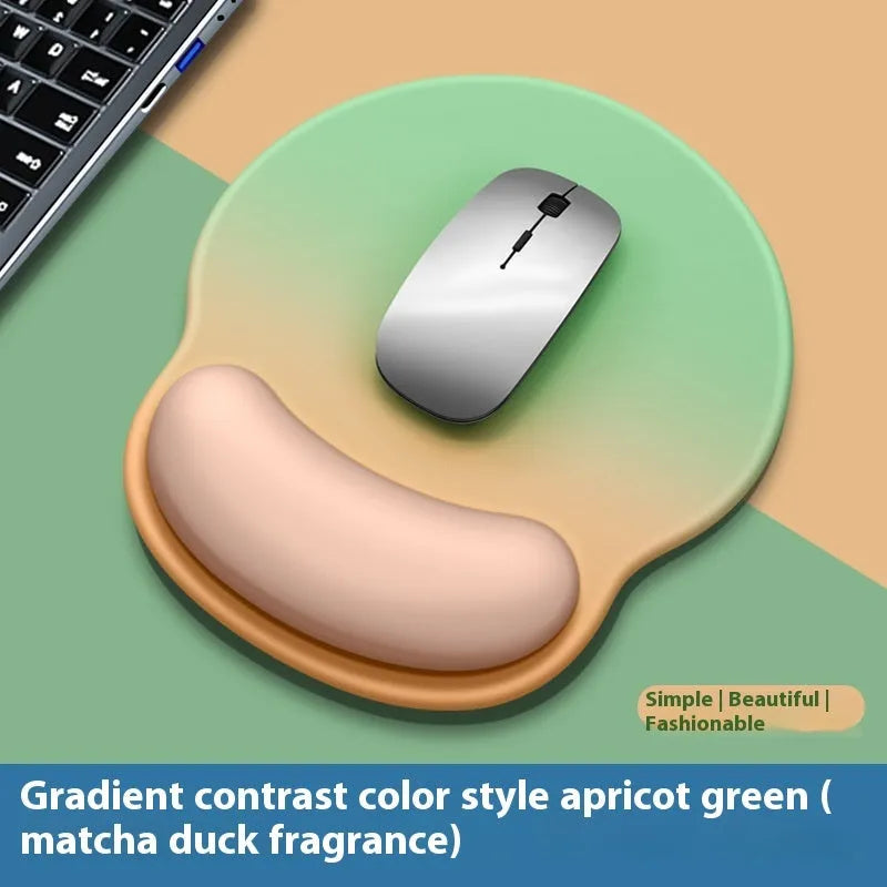 Silicone mouse mat with wristband in a gradient blue black colour pattern on a desk.