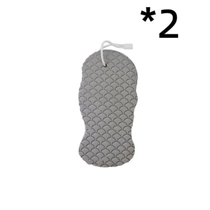 White 3D bath ball sponge with a fish scale exfoliating texture on a blue background.