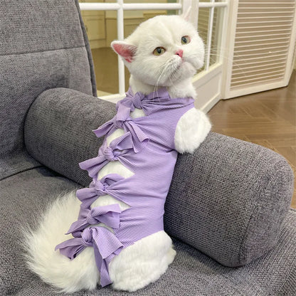 Lace-up cat sterilisation clothing in five colours including pink, purple, blue, brown, and green pineapple, showing adjustable fastening
