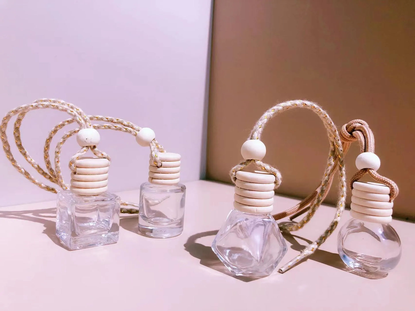 Car perfume pendant in four glass bottle styles: cylinder, diamond, flat drum, and square