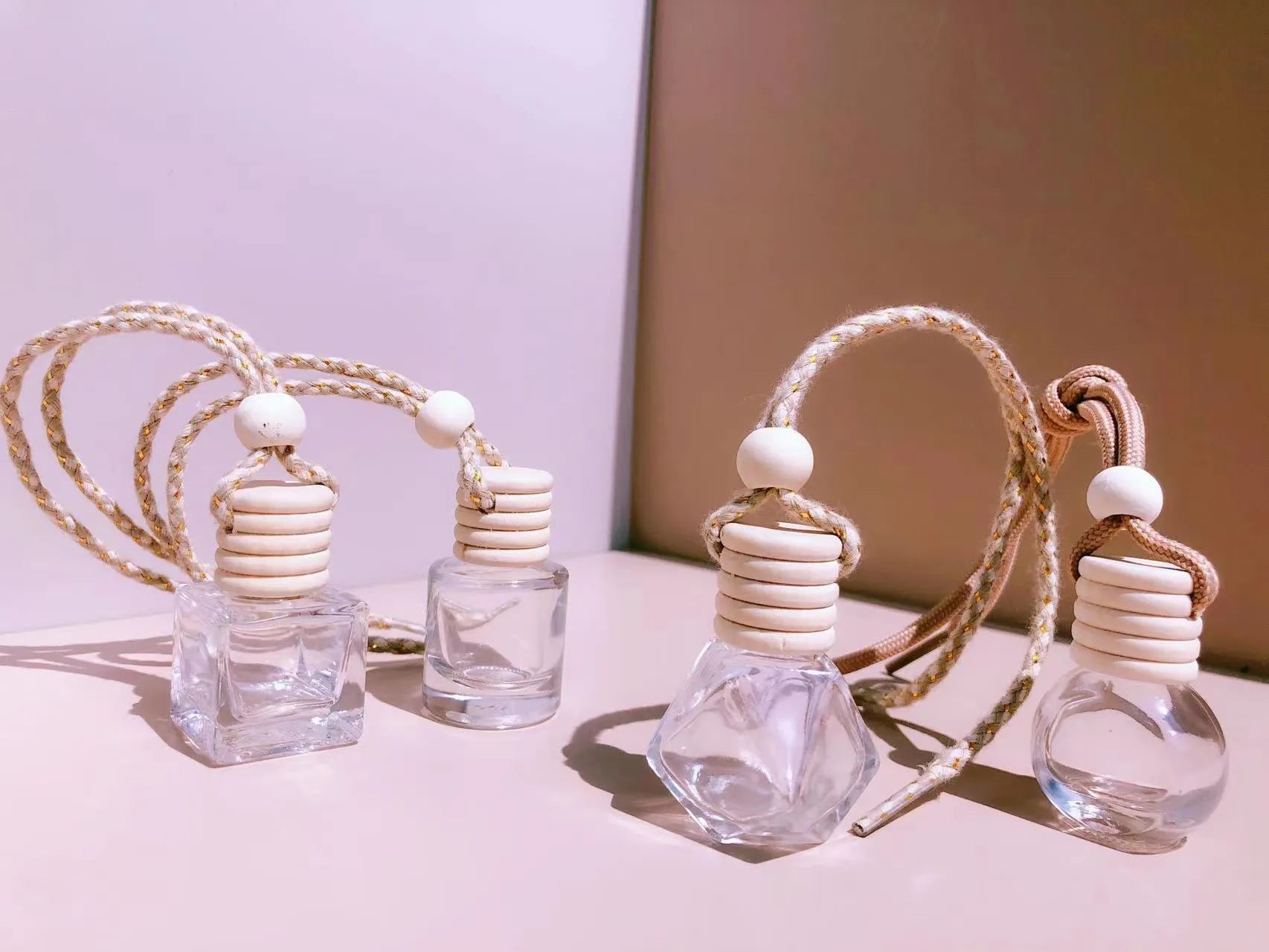Car perfume pendant in four glass bottle styles: cylinder, diamond, flat drum, and square