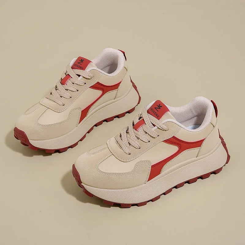 Women's solid colour low-top sports shoes with flat platform sole and lace-up front.
