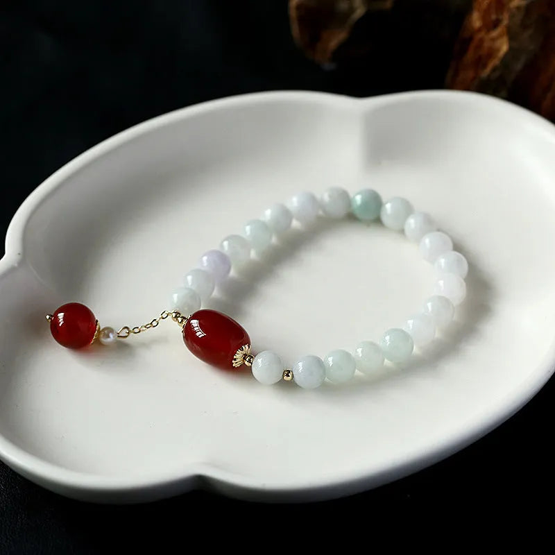 Women's ethnic bracelet with hanging red agate tassel and 14K gilded geometric design
