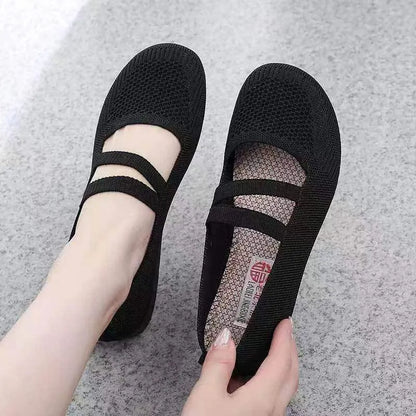 A pair of slip-on flat shoes with an elastic upper and rubber sole, shown in an embroidered colour option.