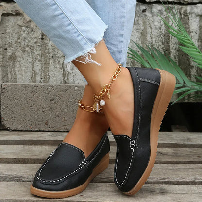 Women's flat shoes with car suture detailing on PU leather upper, round toe, rubber sole, available in multiple colours