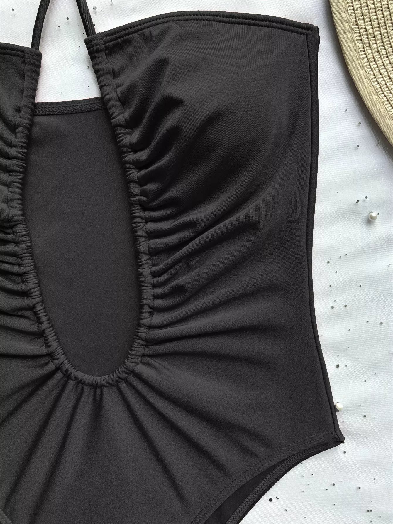 Women's solid color one-piece swimsuit with adjustable strap in brown, black, and rose red