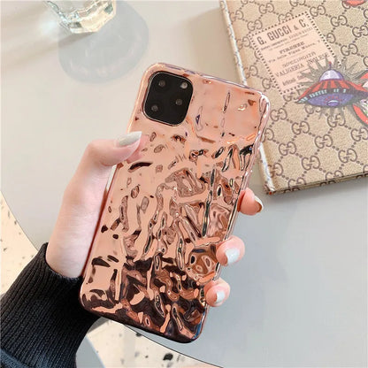 Rose gold electroplated TPU back cover case for iPhone on a table.