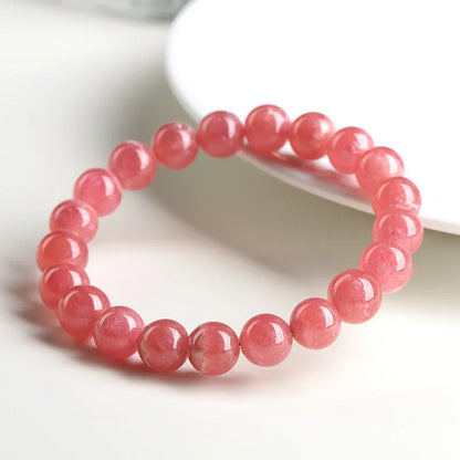 Women's geometric crystal bracelet with red rhodochrosite stones and longevity lock clasp, showing bead size options