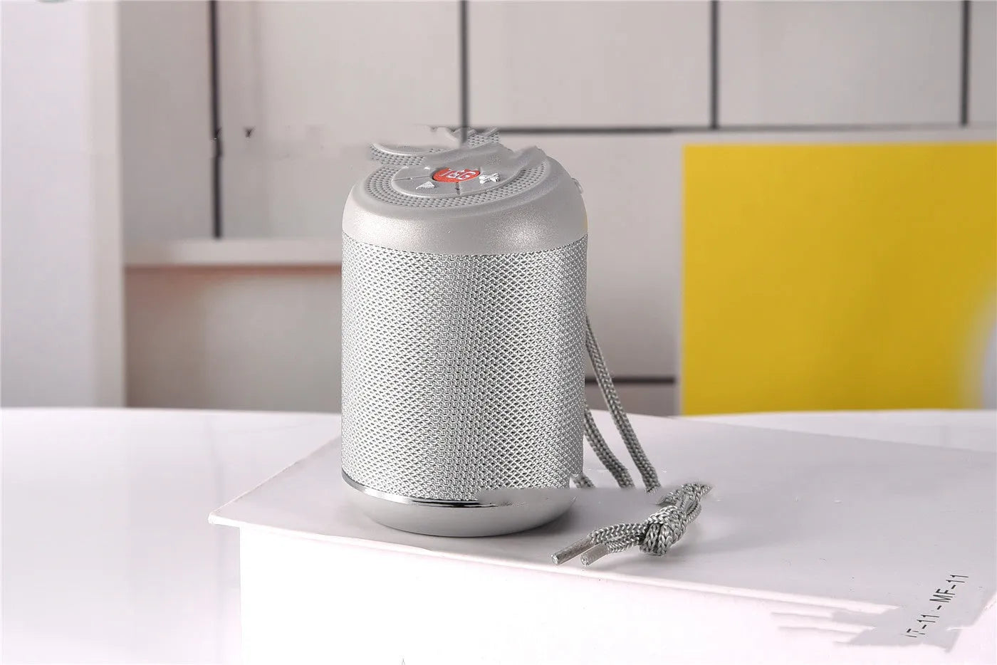 Portable outdoor Bluetooth subwoofer speaker in multiple colours showing button controls.