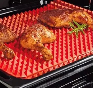 Red silicone pyramid grid cooking mat on a kitchen counter
