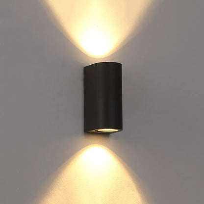 Black LED wall lamp with aluminium body and glass shade mounted on wall