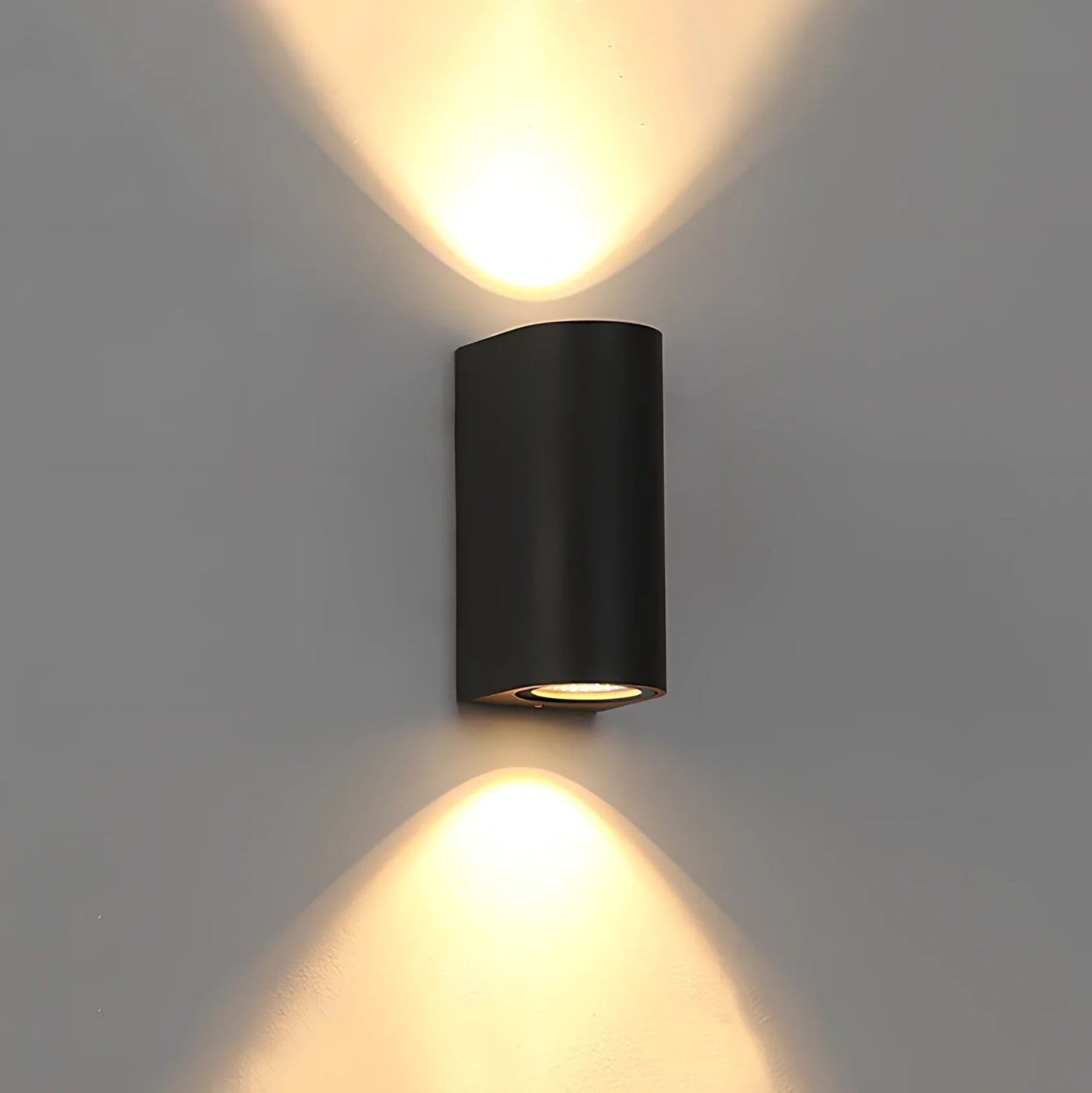 Black aluminium LED wall lamp with tempered glass shade mounted on white wall