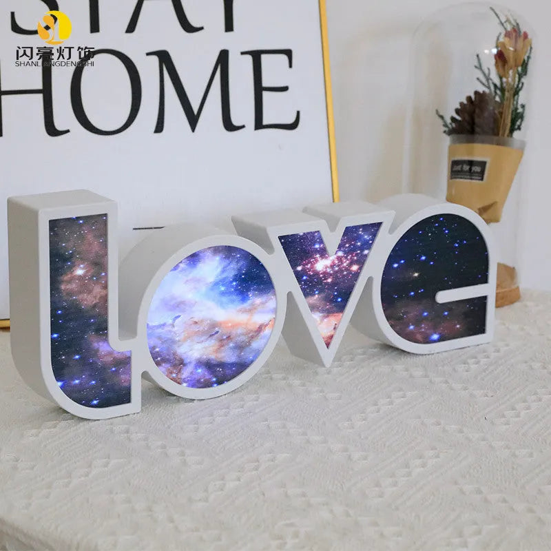 Rainbow halo LED love light with 'LOVE' word decoration on plastic casing.