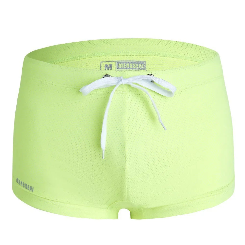 Men's low waist boxer style swimming trunks in nylon, available in multiple solid colours.