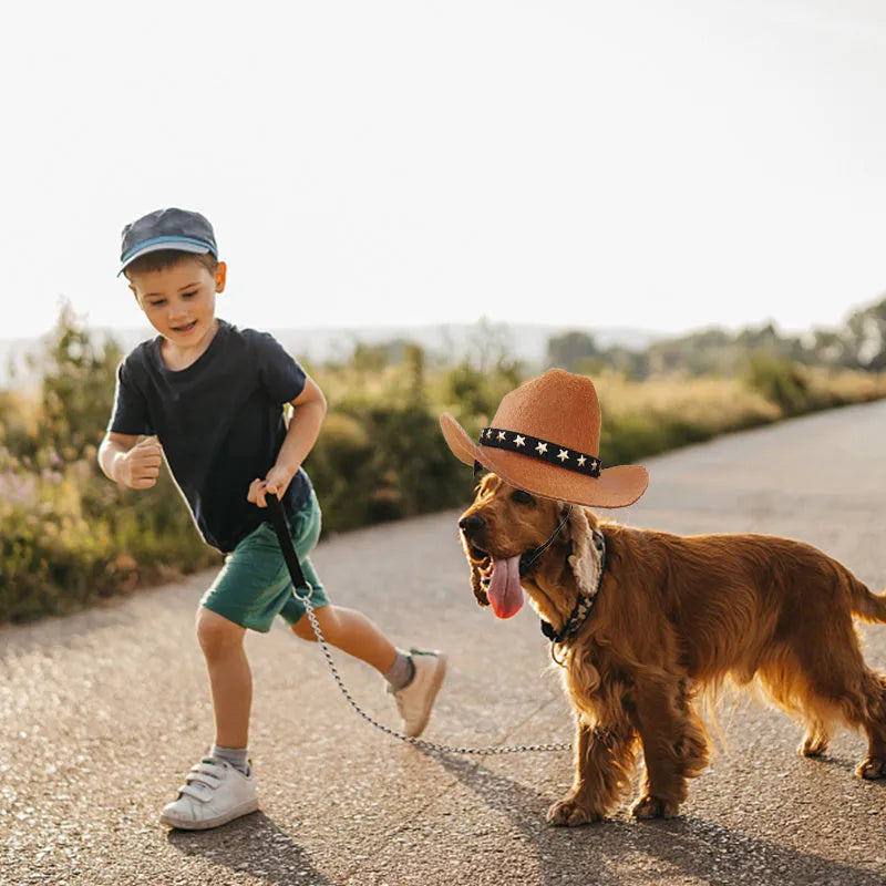 A black pet cowboy hat with a white star on the front, shown with its adjustable elastic strap.