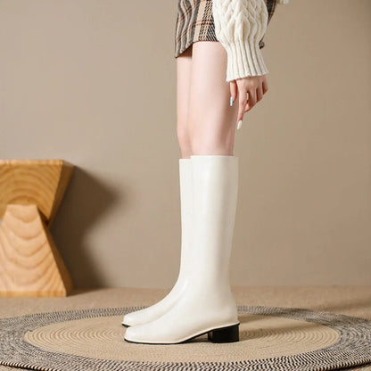 Black square toe over-the-knee boots with 4cm chunky heel showing leather interior and rubber sole