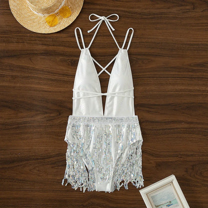 White one-piece swimsuit with deep V-neck and tassel detail, sleeveless brief style.