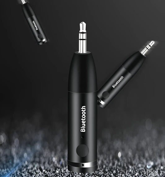 Compact black Bluetooth audio receiver with 3.5mm jack for car stereo and USB cable.