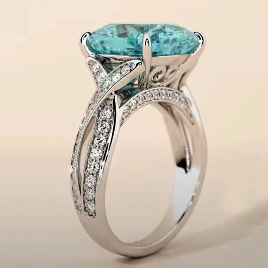 Adjustable women's ring with 4mm square blue zircon stone on silver-tone band