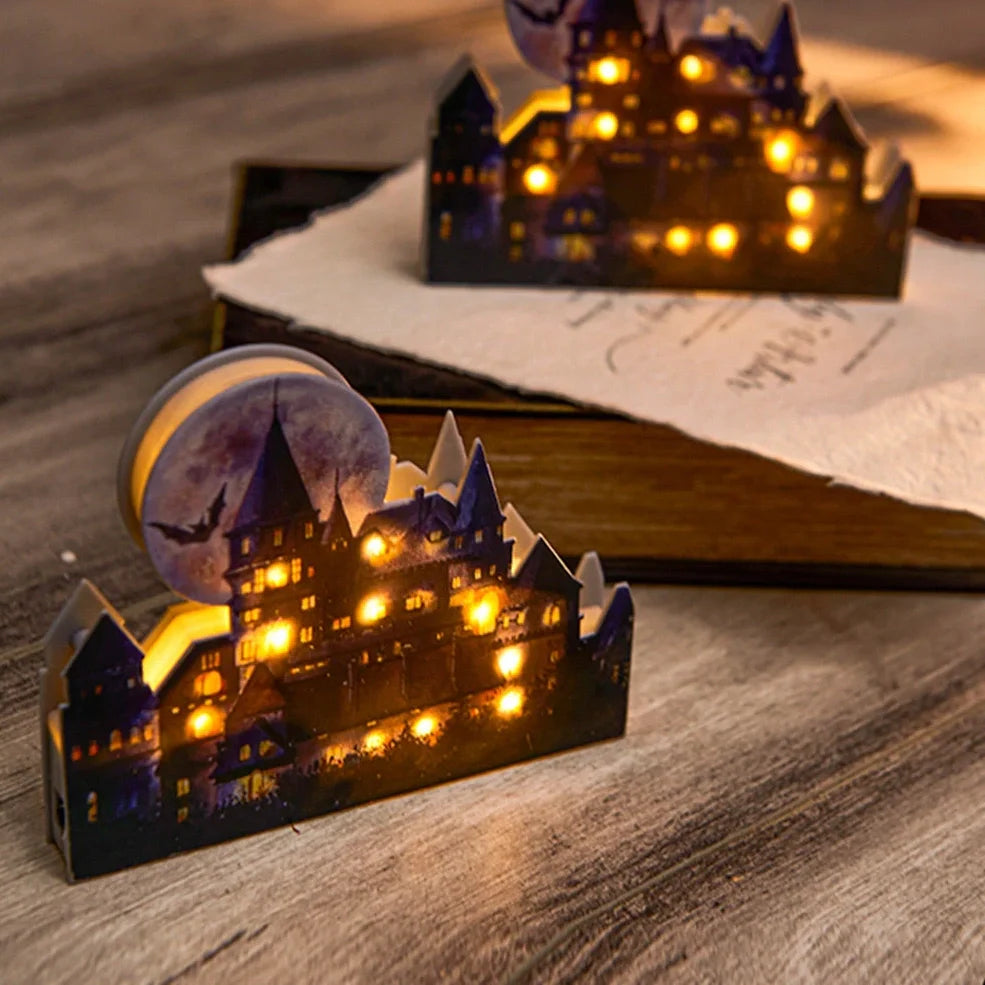 LED illuminated castle ornament with turrets and textured surfaces on desktop