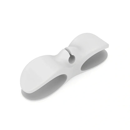 Black TPU cable organizer clips winding appliance cords on kitchen counter, 5cm size, non-marking adhesive for tidy management