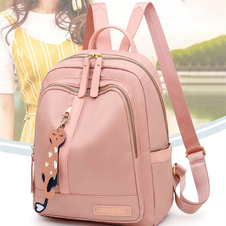 Black square vertical nylon backpack with double shoulder straps showing multiple compartments and anti-theft features