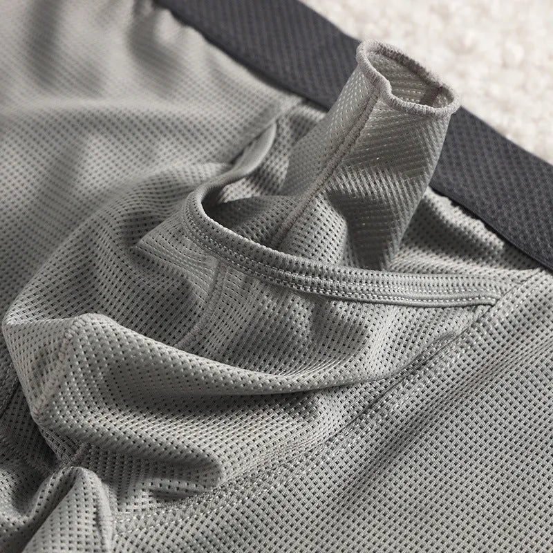 Men's ice silk boxer briefs in black, white, and grey colours showing mesh fabric and low-waist design