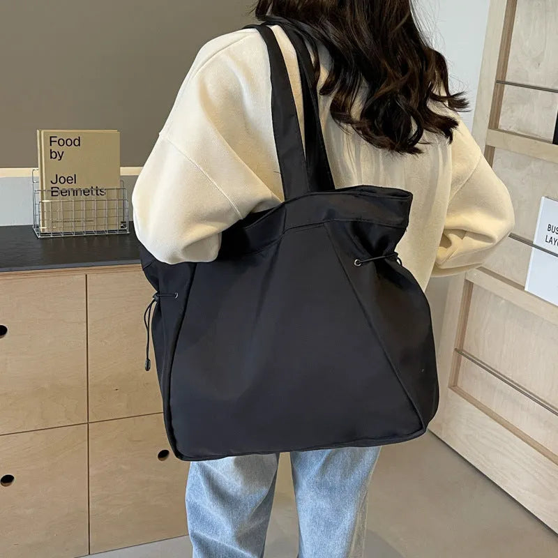 Soft Oxford cloth foldable commuter tote bag in street style, shown in multiple colour options.