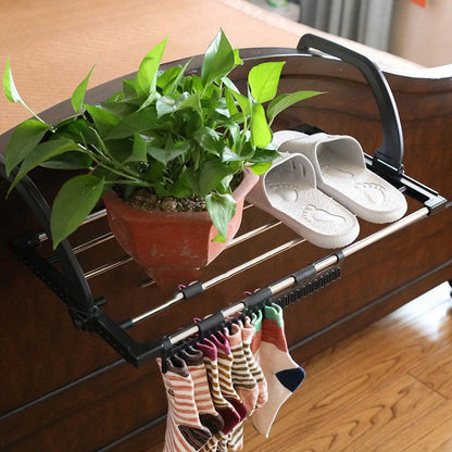 Foldable stainless steel balcony drying rack in black, perfect for saving space while drying clothes and shoes
