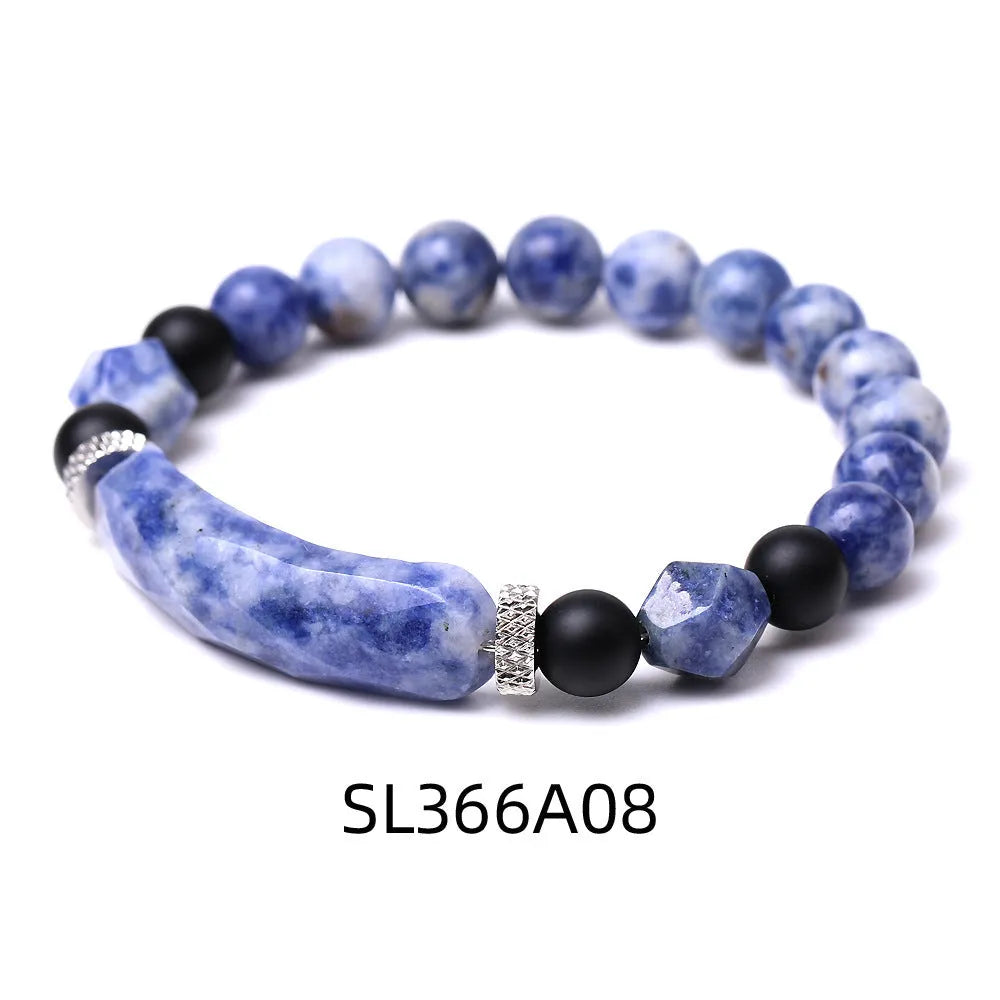 Handmade diamond-shaped cut black agate bracelet with fan-shaped details on a wrist.