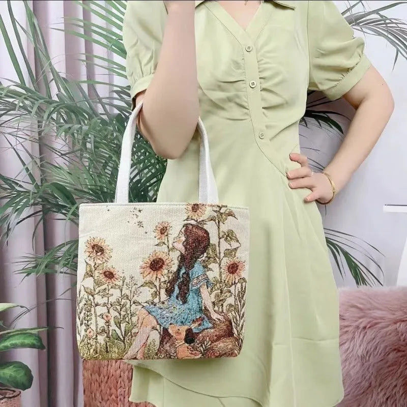 Colourful embroidered canvas shoulder bag with gold wire handles shown in small, medium, and large sizes.