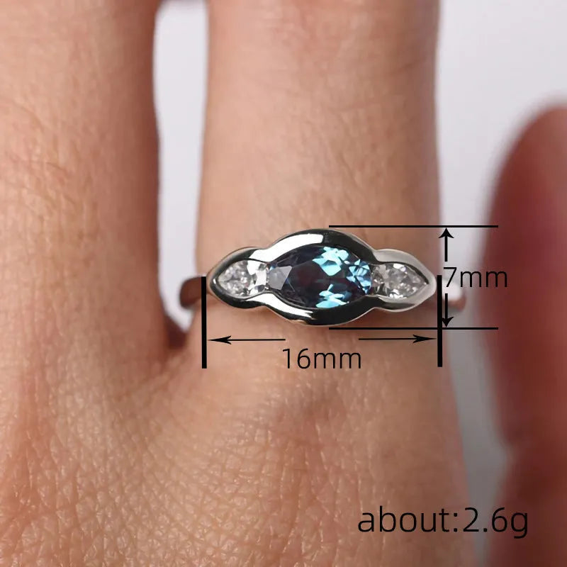 Women's geometric ellipse copper ring with inlaid zircon in white gold colour, showing distinctive non-circular shape